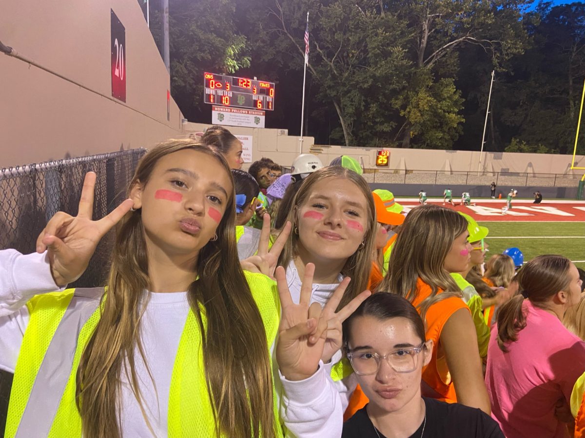 Go, fight, win. Sophomores Katelyn Friestead, Kyrah Morey, and Callie Etscheid  pose for a photo taken at the LP versus Ottawa game on Friday, September 13th. "Football games are always fun to go to, especially with friends in the student section," Friestead said. 