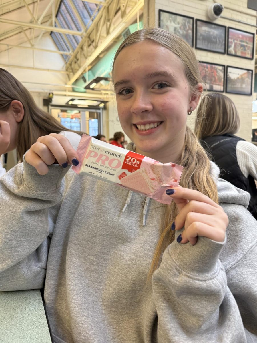 Sophomore Avery Siembab shows off one of her favorite breakfast bars, strawberry Power Crunch. She likes it because it’s easy to take on the go and tastes better than other bars. 