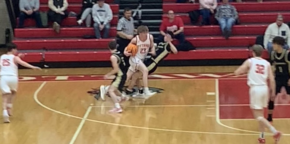 He shoots, he scrores. Junior Owen Sanders slams an opposing player from Sycamore to the ground to make a layup.