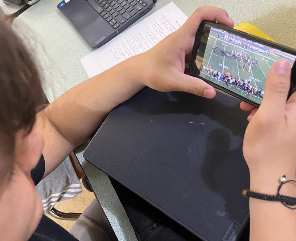 Football Fanatic. Lineman John Ruiz looks over the film to remember his plays. He was told to prepare for his away game against Kaneland. “After practice I often don’t have much time to do much of anything, so I make time to watch my plays when I can.” 