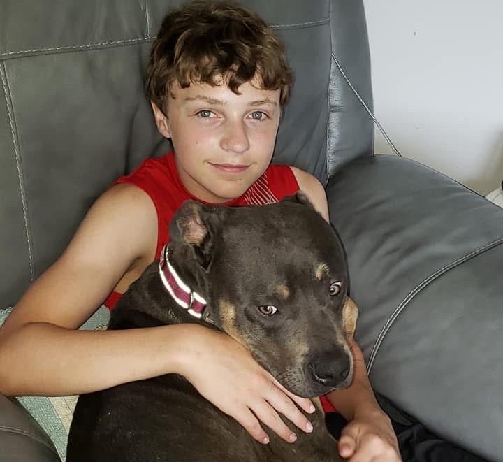 Senior Logan Mills poses with his pet dog when he was younger.