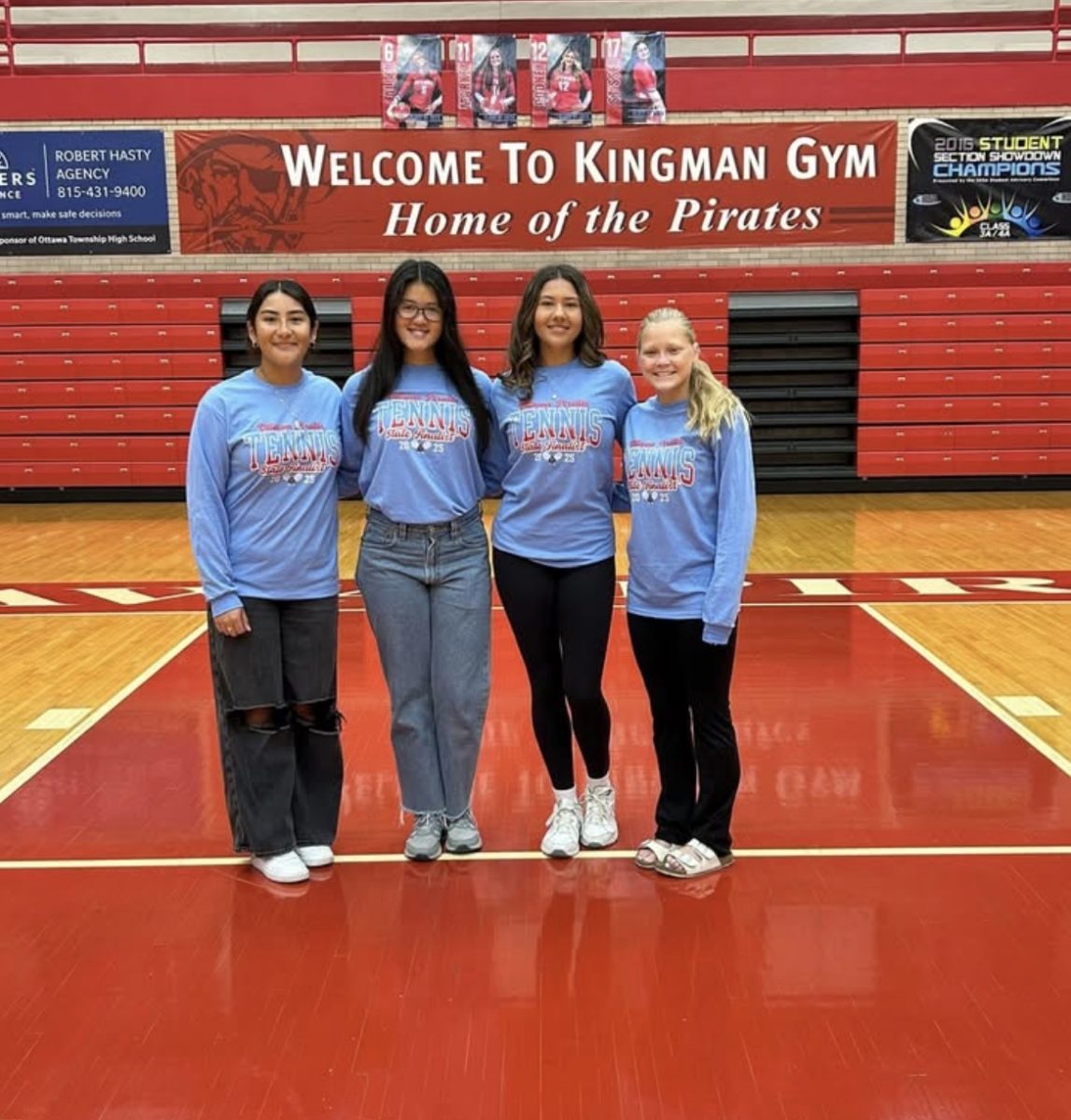 All four Girls Tennis Seniors pose together in Kingman Gym before taking off for their shot at a State Championship.