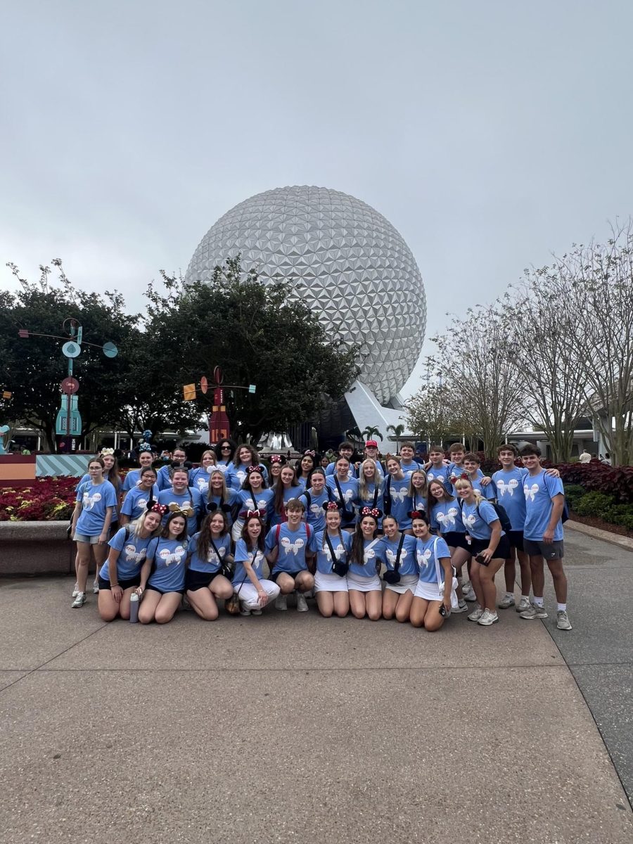 Students at Disney pose in their matching shirts in front of the Epcot Ball before their first leadership program.