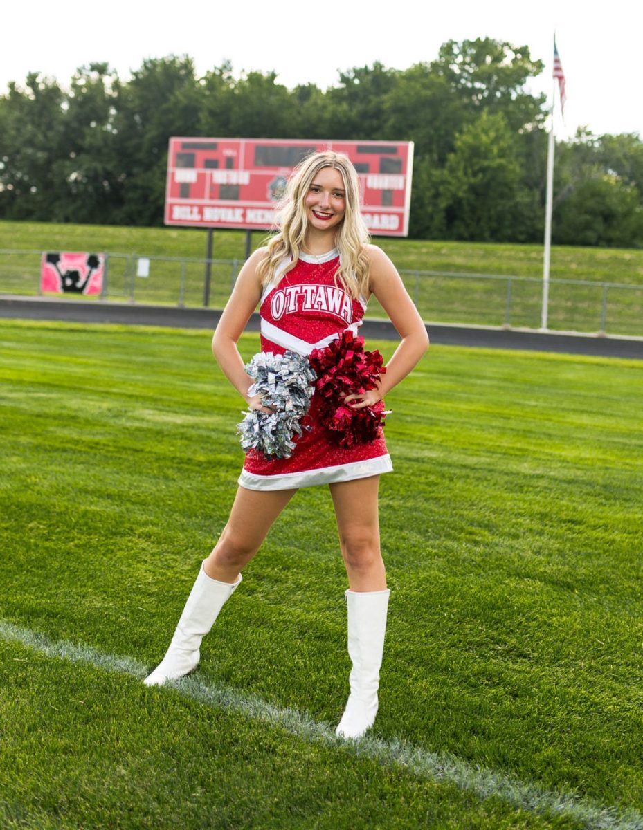 Senior Aubrey Maubach posing for her pom's pictures.