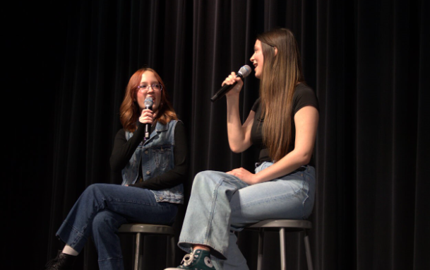 Juniors Shelby Domoleczny and Arden Chechowicz singing on stage during the first student talent section.